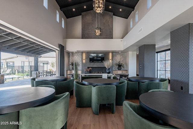 community lobby with high vaulted ceiling, beamed ceiling, and wooden ceiling