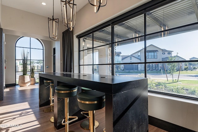 bar area with wood finished floors and baseboards