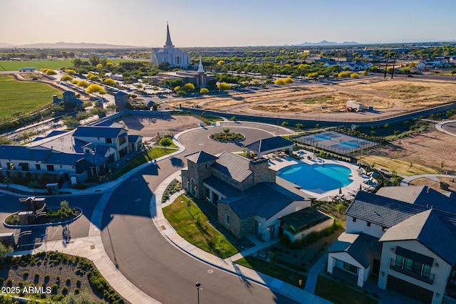 drone / aerial view of a mountain backdrop and a pool area