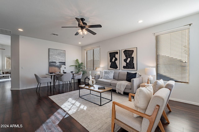 living room featuring dark hardwood / wood-style flooring and ceiling fan