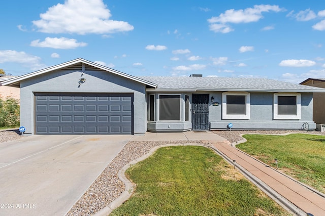 ranch-style house featuring a garage and a front lawn