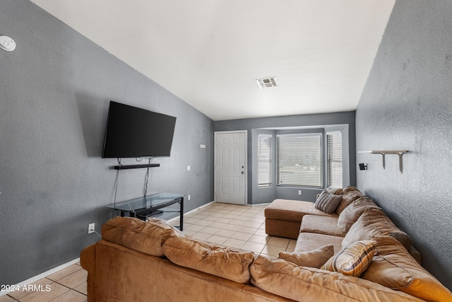 living room featuring lofted ceiling and light tile patterned floors