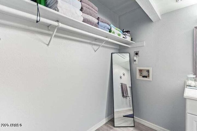 clothes washing area featuring hookup for an electric dryer, light wood-type flooring, baseboards, and hookup for a washing machine