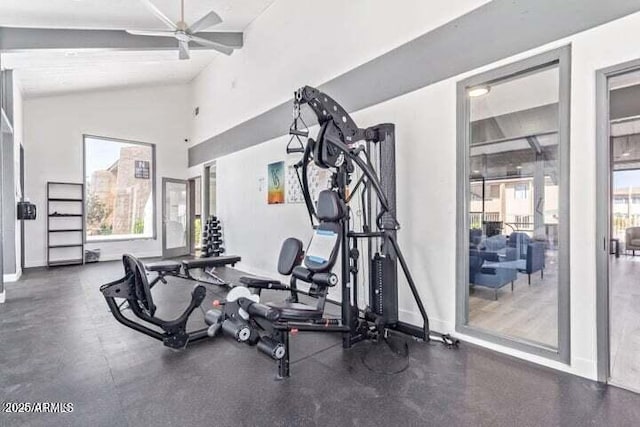 workout area with baseboards, ceiling fan, and lofted ceiling