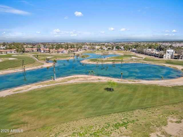 drone / aerial view featuring a residential view, view of golf course, and a water view