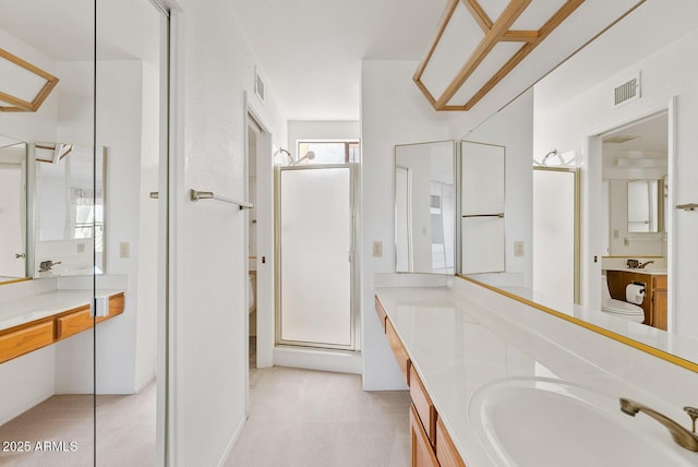 full bath featuring a stall shower, vanity, and visible vents