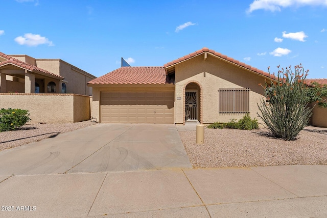 view of front facade with stucco siding, concrete driveway, fence, a garage, and a tiled roof