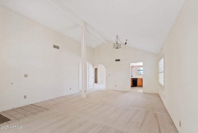 unfurnished room with arched walkways, visible vents, light carpet, high vaulted ceiling, and beamed ceiling