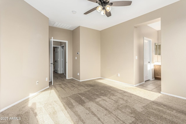 carpeted spare room featuring ceiling fan