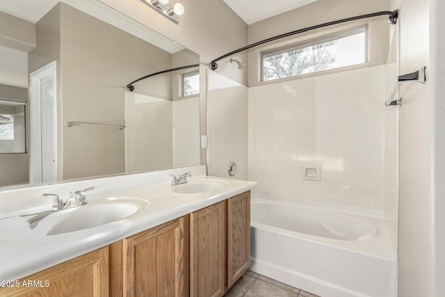 bathroom with washtub / shower combination, tile patterned floors, and vanity