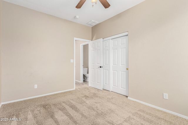 unfurnished bedroom featuring light colored carpet, ceiling fan, and a closet