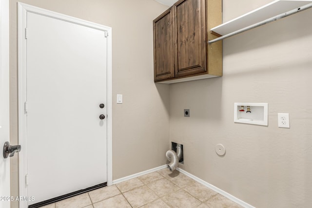 clothes washing area featuring gas dryer hookup, cabinets, light tile patterned floors, hookup for a washing machine, and hookup for an electric dryer