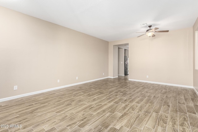 empty room featuring ceiling fan and light wood-type flooring