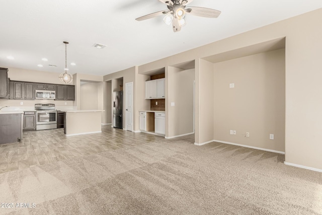 unfurnished living room featuring light carpet and ceiling fan