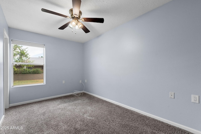 unfurnished room with baseboards, carpet flooring, and a ceiling fan