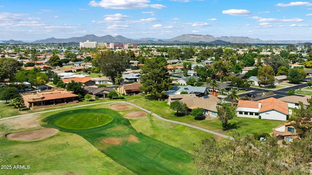 aerial perspective of suburban area featuring a mountain backdrop and a golf course