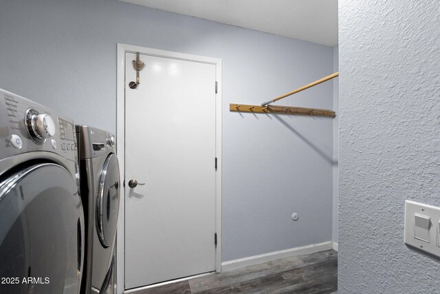 washroom featuring washer and dryer and wood finished floors