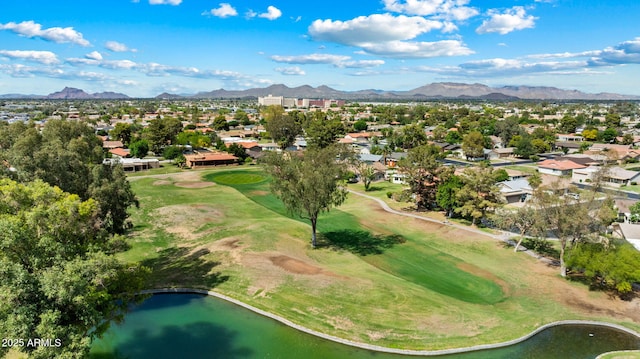 aerial view of property's location featuring a golf club, nearby suburban area, and a water and mountain view