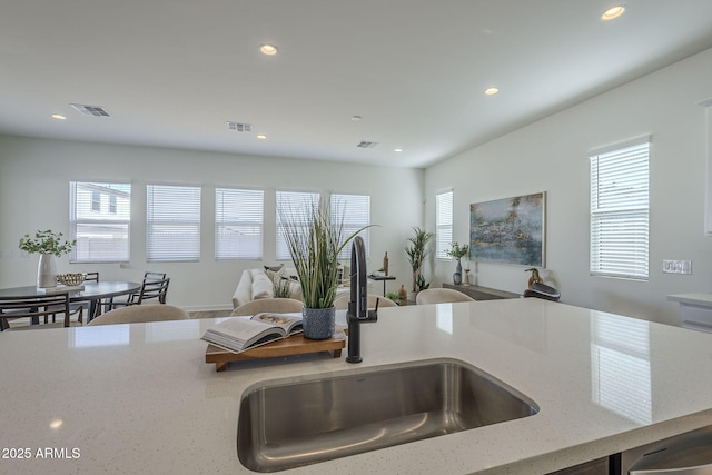 kitchen featuring a sink, visible vents, and a healthy amount of sunlight