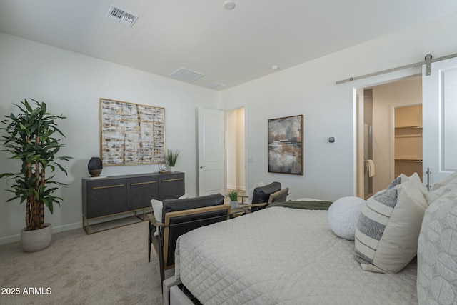 bedroom featuring baseboards, a barn door, visible vents, and light colored carpet