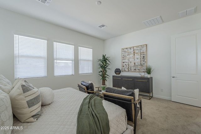 bedroom featuring baseboards, visible vents, and light colored carpet