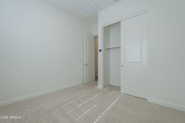 unfurnished bedroom featuring carpet floors, a closet, and baseboards