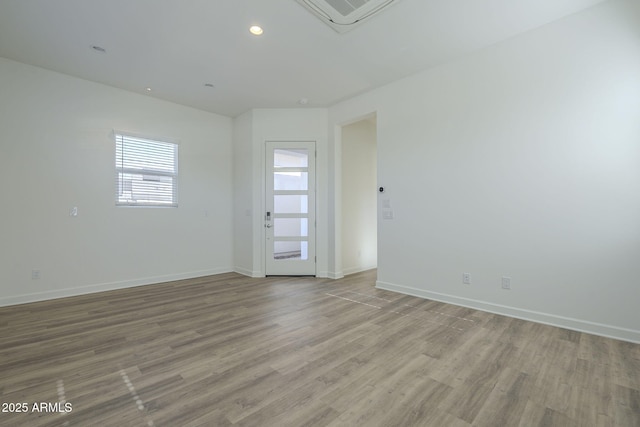 unfurnished room with recessed lighting, visible vents, baseboards, and wood finished floors