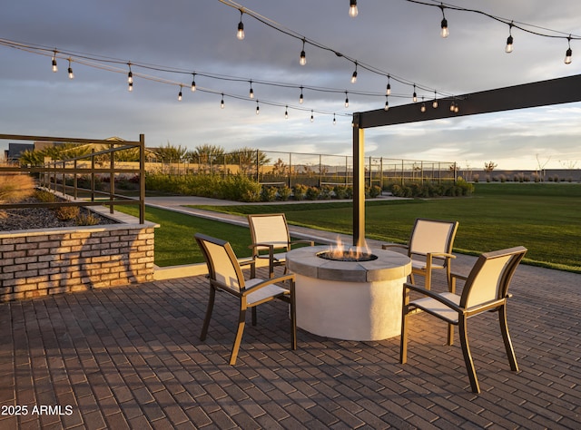 view of patio / terrace with an outdoor fire pit and fence