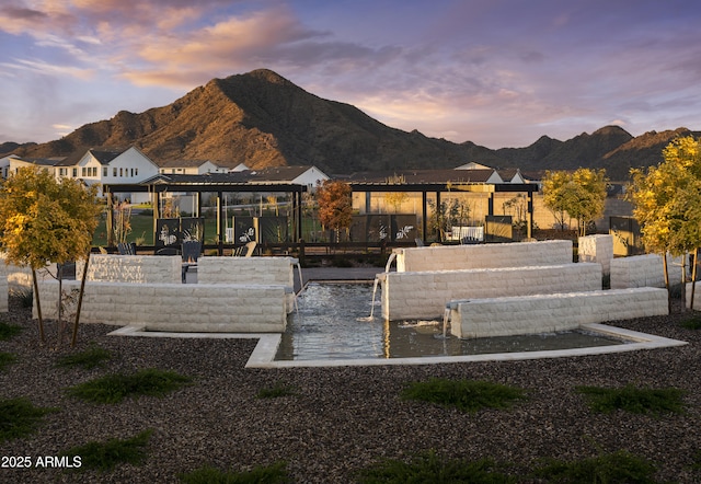 view of property's community featuring a boat dock and a mountain view