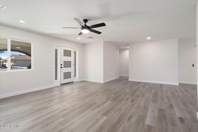 empty room featuring ceiling fan and light hardwood / wood-style flooring