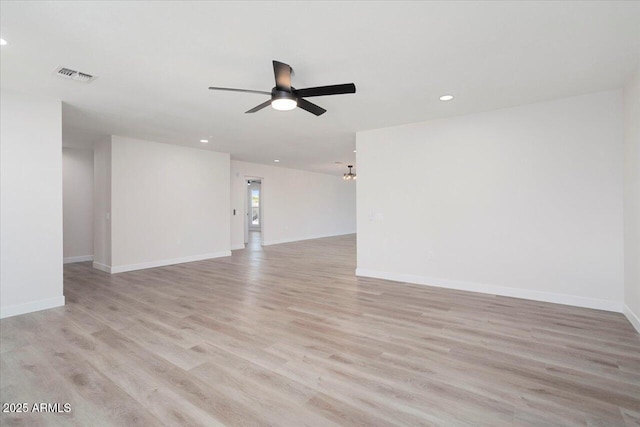 empty room with ceiling fan and light hardwood / wood-style flooring