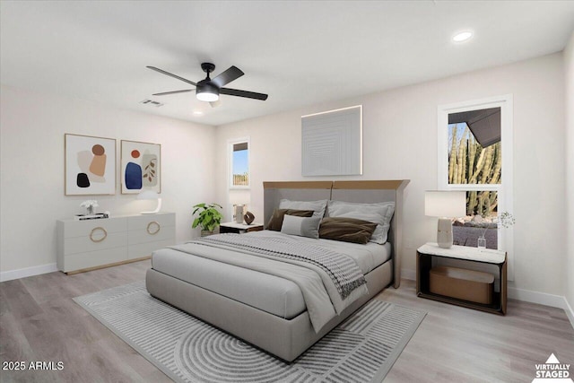 bedroom featuring light hardwood / wood-style floors and ceiling fan