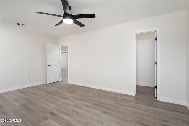 spare room featuring light hardwood / wood-style flooring and ceiling fan