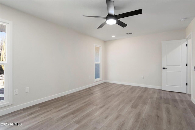 spare room featuring ceiling fan and light hardwood / wood-style flooring