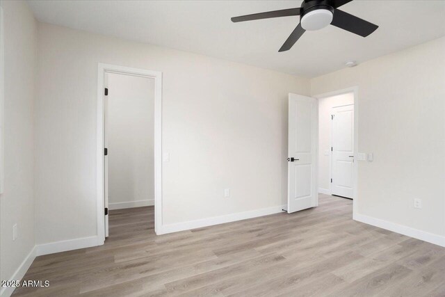 spare room featuring ceiling fan and light hardwood / wood-style floors