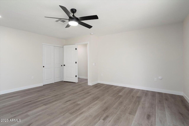 spare room featuring ceiling fan and light wood-type flooring