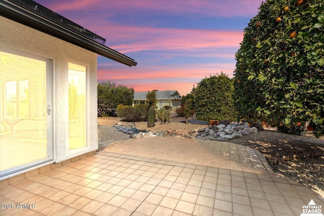 view of patio terrace at dusk