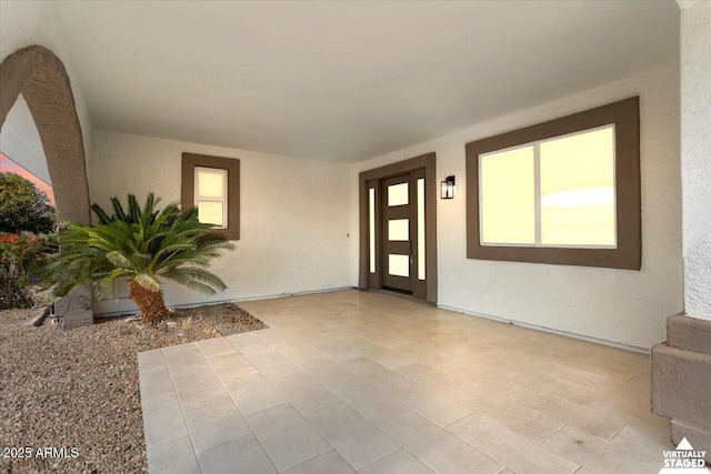 doorway to property with a patio area