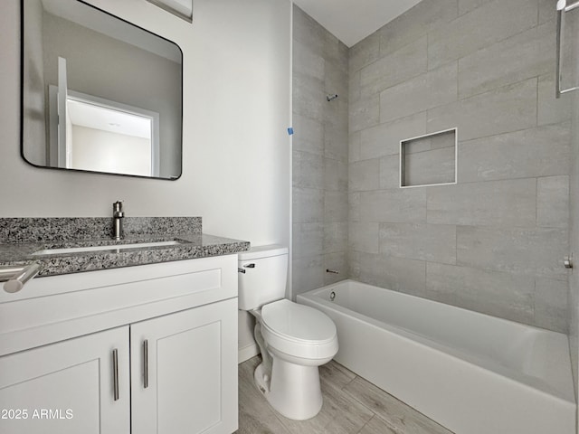 full bathroom with vanity, toilet, and tiled shower / bath combo