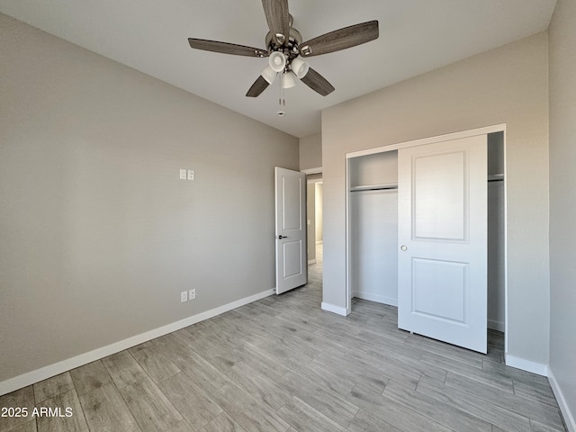 unfurnished bedroom featuring ceiling fan, light hardwood / wood-style floors, and a closet