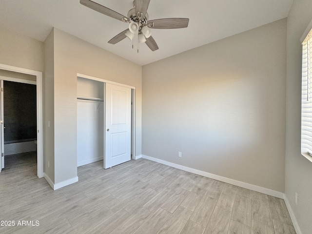 unfurnished bedroom featuring multiple windows, ceiling fan, a closet, and light wood-type flooring