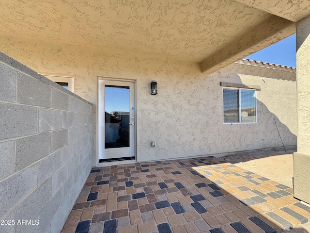 entrance to property with a patio