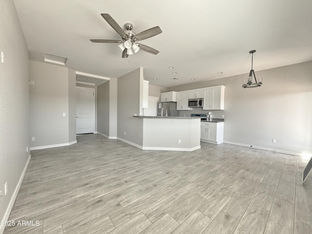 unfurnished living room featuring ceiling fan