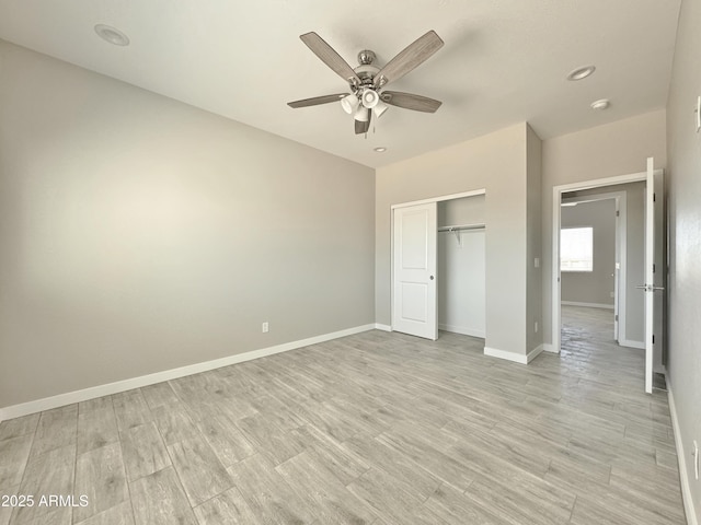 unfurnished bedroom with light hardwood / wood-style floors, a closet, and ceiling fan