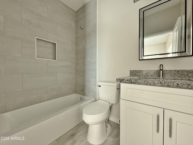 full bathroom with hardwood / wood-style floors, vanity, toilet, and tiled shower / bath combo