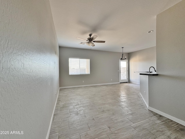 unfurnished room with ceiling fan