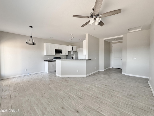 kitchen with stainless steel appliances, ceiling fan, light hardwood / wood-style flooring, white cabinetry, and hanging light fixtures