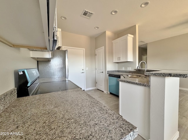 kitchen with kitchen peninsula, range with electric cooktop, sink, dishwasher, and white cabinets