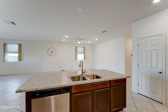 kitchen featuring stainless steel dishwasher, plenty of natural light, a center island with sink, and sink