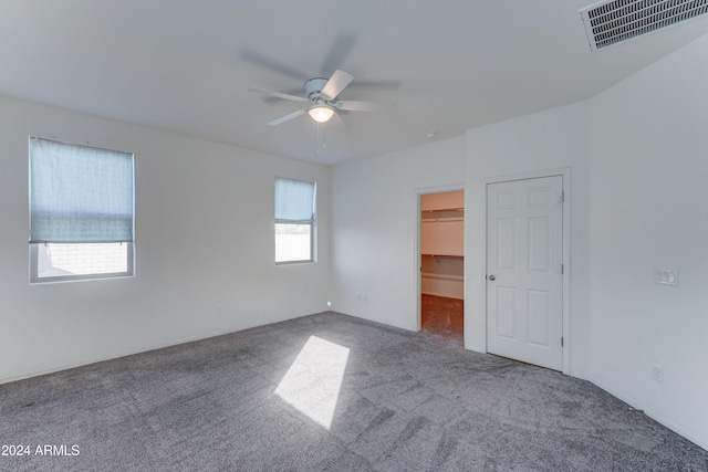 empty room with ceiling fan and carpet floors